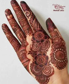 the hand is decorated with intricate designs