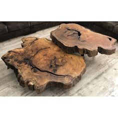 two pieces of wood sitting on top of a wooden floor in front of a couch