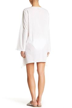 Casual yet chic, this cover up dress is the perfect mate for your bikini. Embellished with beautiful embroidery , the throw on and ready to go style is comfortable and easy to wear. This tunic-style v-neck dress is a must have from the house of La Moda. • Dress, Cover Up • Beachwear, Resort Wear • 100% Rayon • Goga Swimwear • Available in White • Size: S/M, L/XL • Washing Instruction: Hand Wash with Cold Water, Tumble Dry, Do not Iron Beachy White V-neck Cover-up, Spring V-neck Beach Dress, Chic Tunic Cover-up For Beach Season, Summer V-neck Tunic For Loungewear, Spring V-neck Beachwear Tunic, Unlined V-neck Cover-up For Vacation, Summer V-neck Tunic For Vacation, White Cotton Beachwear Cover-up, V-neck Kaftan For Resort Season