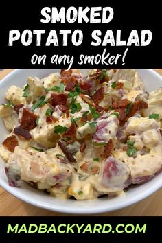 a bowl filled with potato salad on top of a wooden table next to a sign that says smoked potato salad on any smoker