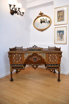 an ornately decorated wooden desk in a room