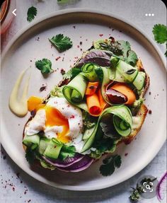 an open face sandwich with avocado, lettuce and eggs on it