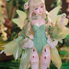 a doll dressed as a fairy with flowers in her hair