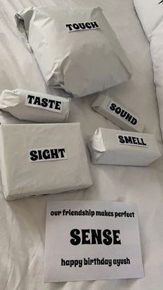 four bags of food sitting on top of a bed with the words taste, sound and smell written on them