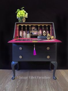 an old dresser with some decorations on top and flowers in the bottom drawer next to it