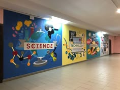 an empty hallway with colorful wall paintings on the walls and tile flooring in front of it