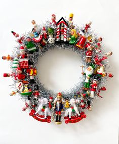 a christmas wreath made out of ornaments and tinsel