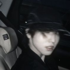 a person in a car wearing a hat