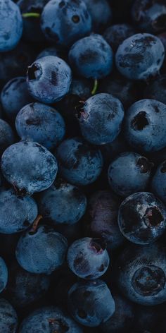 blueberries are piled up in a pile