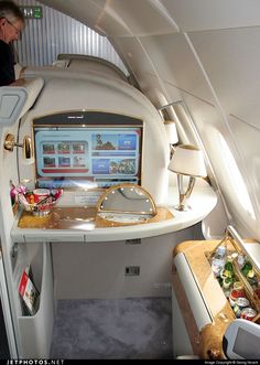 the inside of an airplane with food and drinks on the table in front of it