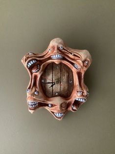 a clock made out of wood with teeth on it