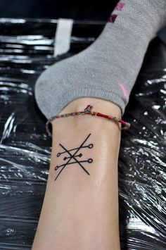 a woman's foot with a tattoo on her left ankle and the word love written in black ink