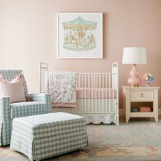 a baby's room with pink walls and blue checkered furniture, including a rocking chair