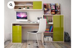 a desk with a computer on top of it next to a book shelf filled with books