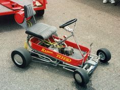 a small red race car sitting on the ground