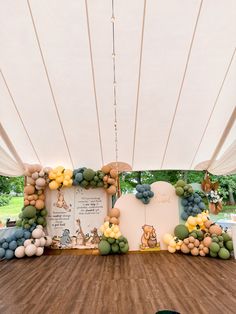 a large white tent with balloons and decorations on it