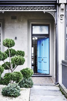 a blue door in front of a house