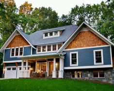 a large blue and white house with lots of windows