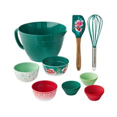 various bowls and whisks are shown with utensils in the middle one has a flowered design on it