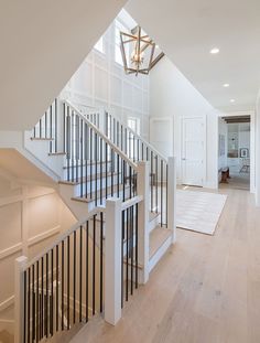 an open floor plan with stairs leading up to the second story and another room in the background