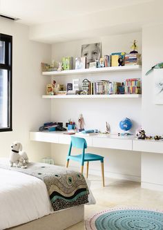 a living room filled with white furniture and a flat screen tv mounted on a wall