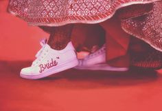 a close up view of someone's feet wearing white tennis shoes with the word bride on them