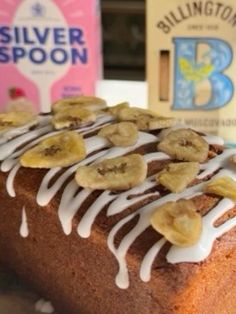 a loaf of banana bread sitting on top of a table next to a bottle of milk