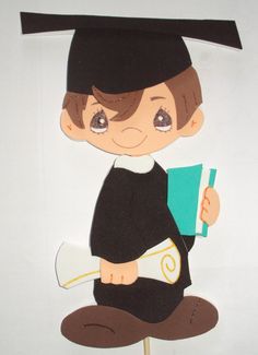 a paper cut out of a boy holding a book and wearing a graduation cap, reading a book