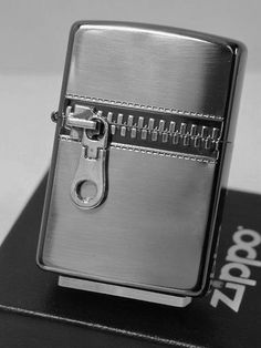 a silver lighter sitting on top of a black box