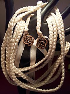 white and black braided necklaces are on display