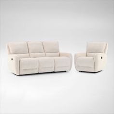 two white reclining sofas sitting next to each other