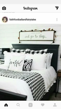 a bed with black and white comforter, pillows and throw pillows on top of it