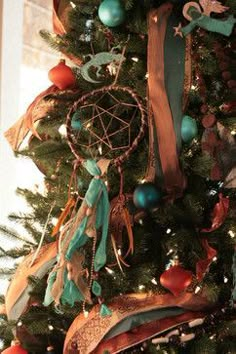 a christmas tree decorated with ornaments and ribbons