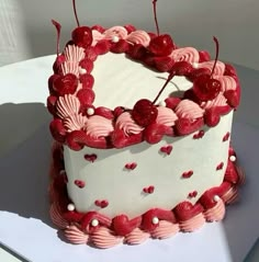 a white and red cake with hearts on it