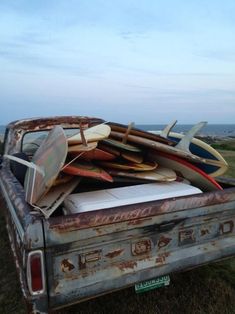 an old pick up truck with surfboards in the back