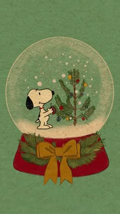 a snow globe with a snoopy christmas tree in it and a yellow bow on the bottom