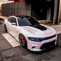 a white car parked in front of a building