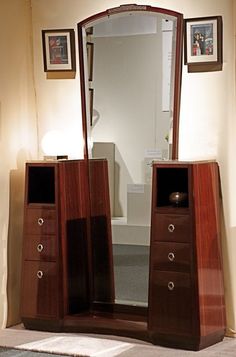 a mirror sitting on top of a wooden dresser