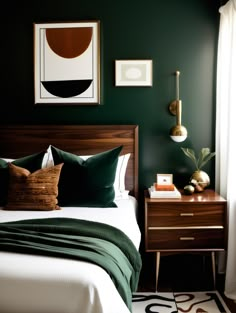 a bedroom with dark green walls, white bedding and artwork on the wall above it