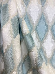 an upholstered blue and white patterned fabric