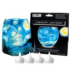 three white candles in front of a box with the starry night painting on it