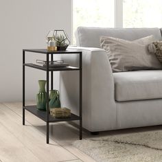 a living room scene with focus on the sofa and coffee table in the foreground