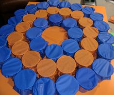 an orange table topped with blue and brown cupcakes