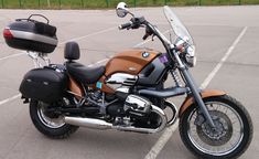 a brown motorcycle parked in a parking lot