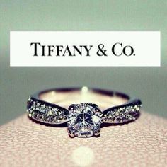 an image of a ring with diamonds on it and the words tiffany & co written below