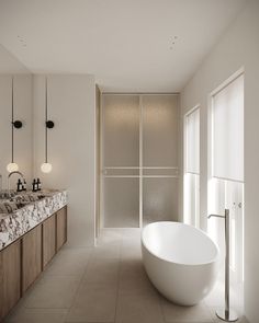 a large white bath tub sitting in a bathroom next to a sink and mirror on the wall