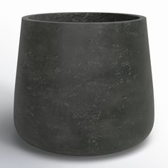 a black vase sitting on top of a white table