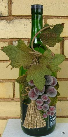 a wine bottle with grapes and leaves on it