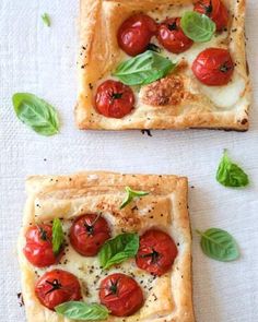 two square pizzas topped with tomatoes and basil