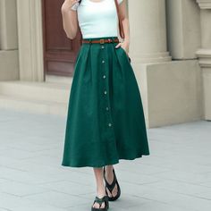 Showcase your style in a sophisticated mid-calf A-line skirt, beautifully tailored in a lush shade of green. The skirt features a distinctive button detail that adds a unique touch. Ideal for the blooming season of spring, this skirt is a perfect addition to any plus size wardrobe.  DETAIL * 100% Linen * Two side pockets * Back elastic waist * Button front skirt * Below Knee Length * Midi skirt  * A Line skirt * Perfect for Spring, Summer and Autumn * Wash by hand or machine with cold water * Mo Buttoned Long Skirt For Day Out, Relaxed Skirt With Buttoned Pockets For Spring, Long Skirt With Buttons For Day Out, Summer Workwear Skirt With Buttoned Pockets, Casual A-line Bottoms With Buttons, Spring Workwear Maxi Skirt With Buttons, Summer A-line Skirt With Button Closure, Casual Flared Maxi Skirt With Buttons, Casual Full Skirt With Button Closure